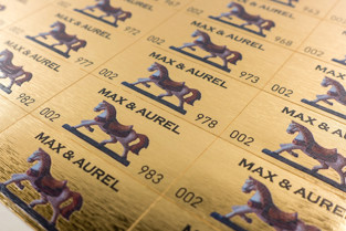 Security stickers made of paper in metallic gold look against counterfeiting attempts, circular die-cutting