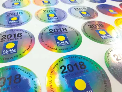 Security sticker with hologram effect and colourful printing