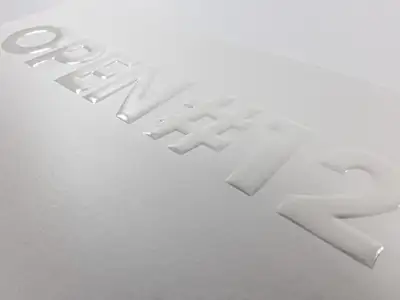 UV varnish and embossing with rounded, protruding letters