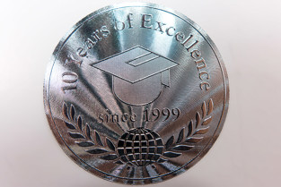 Security sticker made of paper in metallic silver look against counterfeiting attempts, punched in a circle