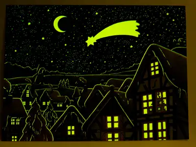 Phosphor paint, also called afterglow paint, glows in the dark on a paper Advent calendar