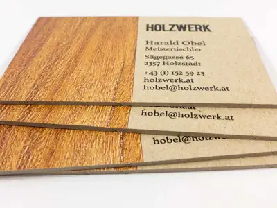 Business cards made of 1.5 mm thick grey cardboard, partly printed in wood look