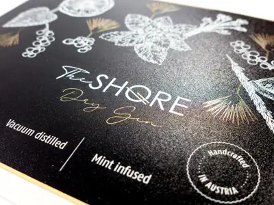 Gold metallic self-adhesive label for a gin with printing and structure varnish