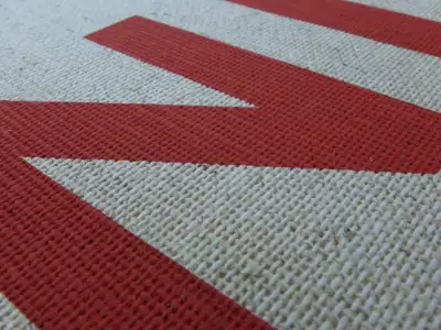 Screen printing red on coarse bookbinder s cloth for hardcover book cover